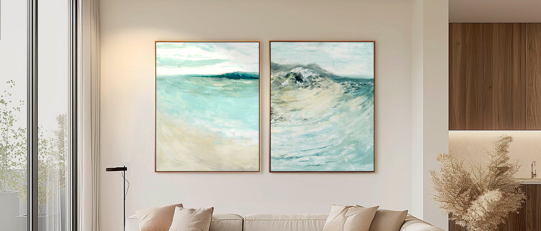 Wall art for living room — large abstract canvas prints in pale blues and sand displayed above a sofa, beautiful statement art for living rooms by Kate Shephard Art.