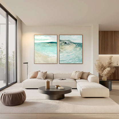 Modern living room with a white sectional sofa, round coffee table, and two abstract seascape paintings prints on the wall.
