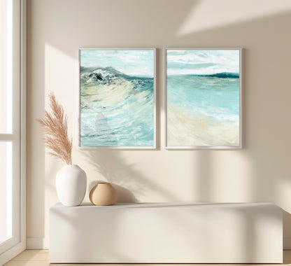 'Coastal Calm' - Set of 2 beach art paintings displayed above a sofa, soft coastal palette in blue and cream.